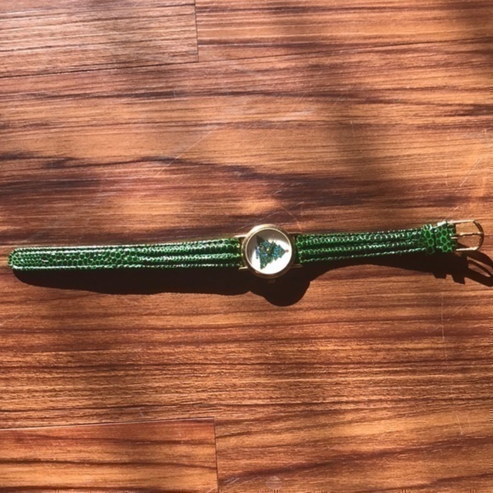 Ladies watch green Xmas tree. Not sure if …